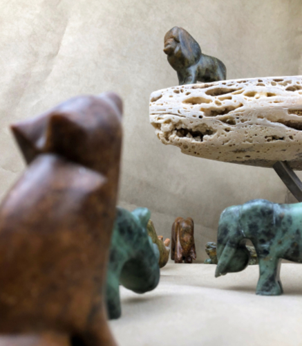 Lion king scene with animals carved from soapstone