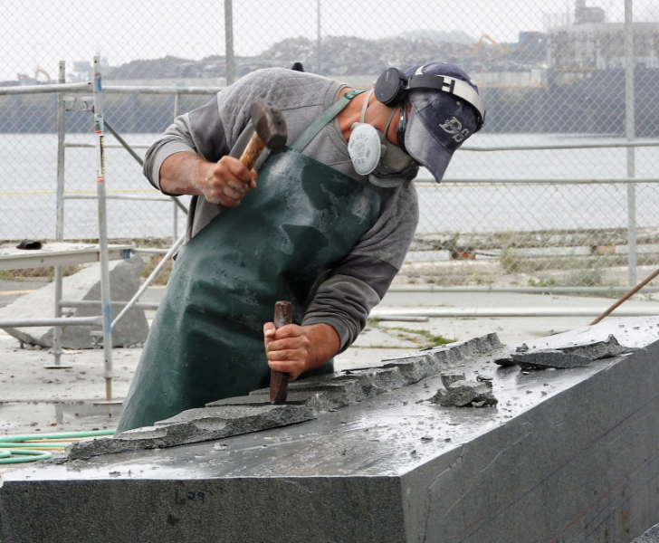 Oliver Harwood cutting a rock outside